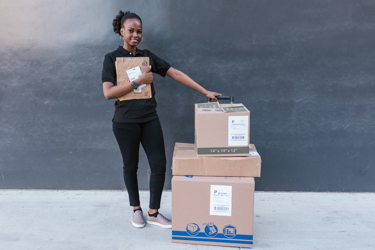 services-01 Confident woman holding delivery packages against a modern backdrop.